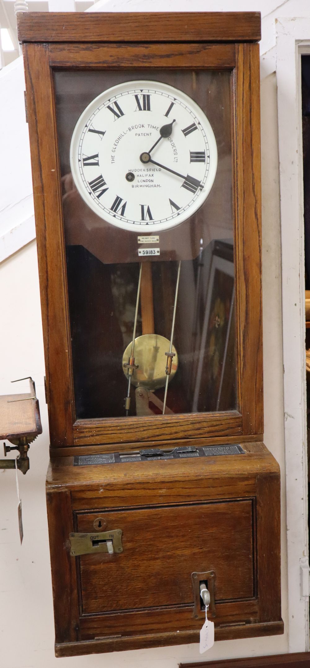 An early 20th century Gledhill-Brook oak cased clocking-in machine, width 40cm, depth 29cm, height 108cm